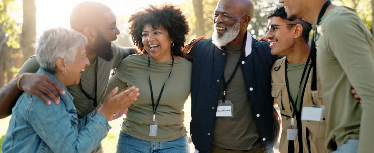 A group of volunteers in a huddle laughing